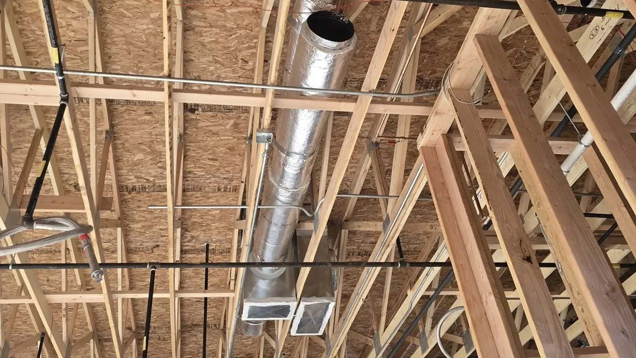 Ductwork running through the attic framing of a new home