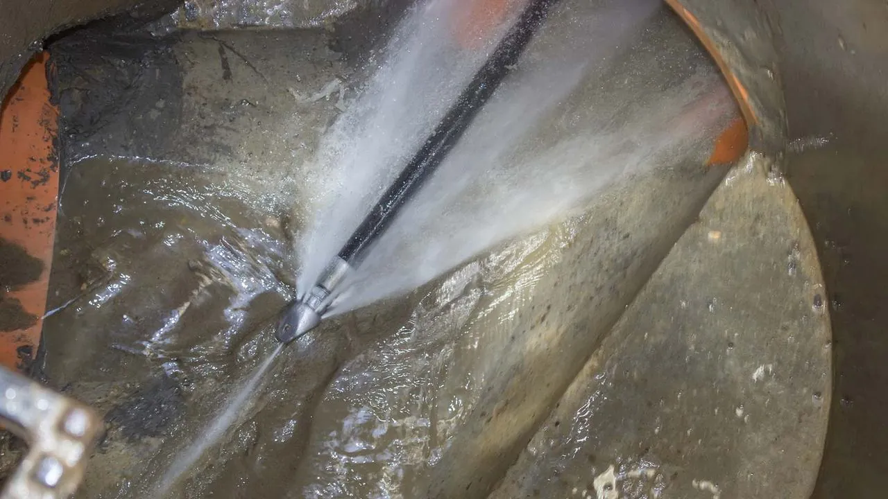 Hydro jet nozzle blasting water inside a pipe