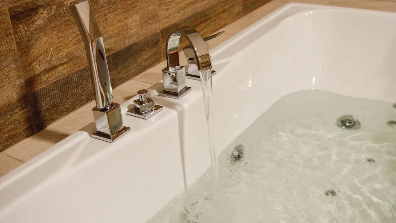 New bathtub faucet filling a jetted tub