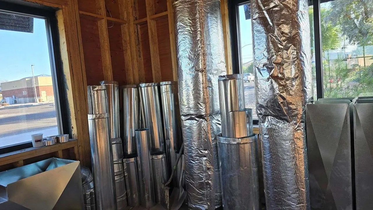 New metal and insulated ductwork stacked inside a home under construction