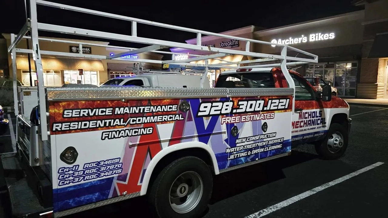 Nichols service truck parked at a shopping center at night