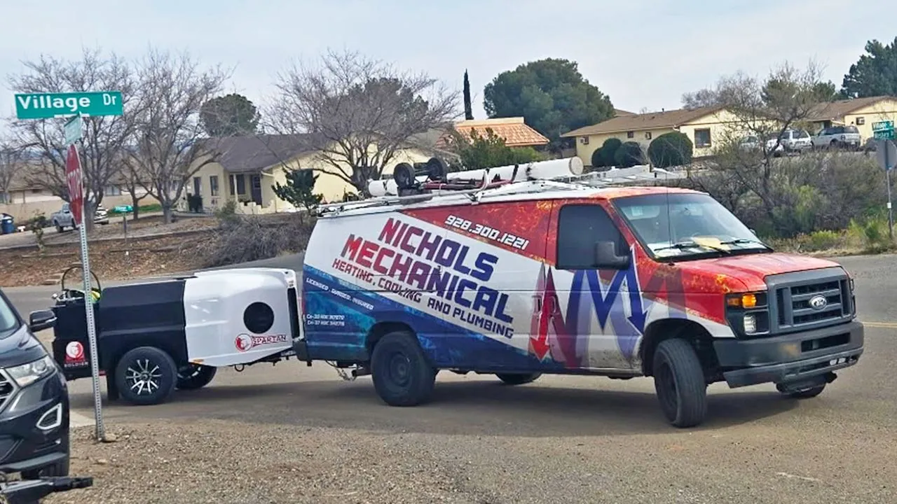 Nichols service van towing a hydro jetting trailer
