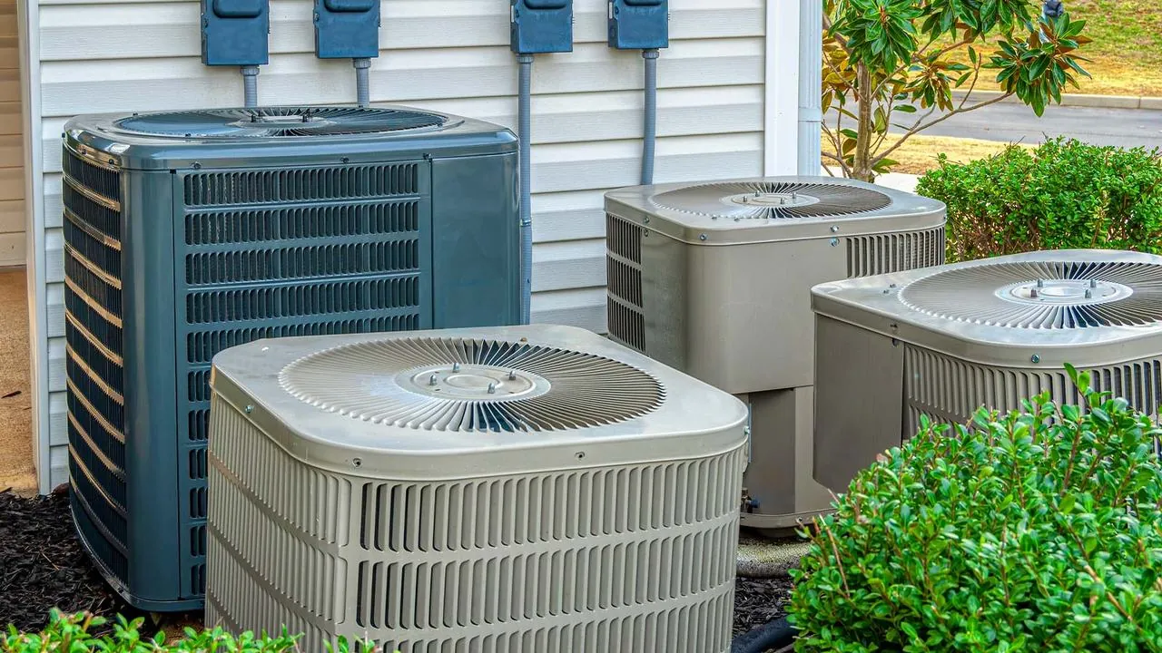 Outdoor heat pump and AC units beside a home