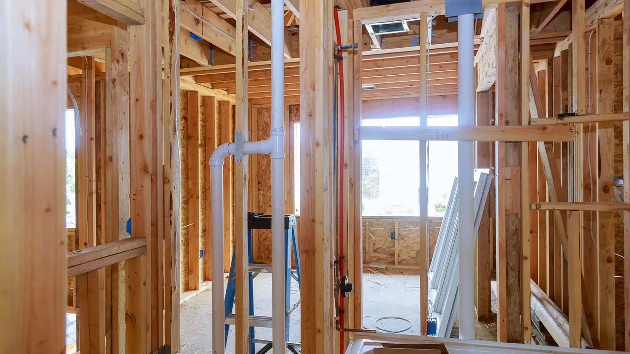 Plumbing lines running through the framing of a new house