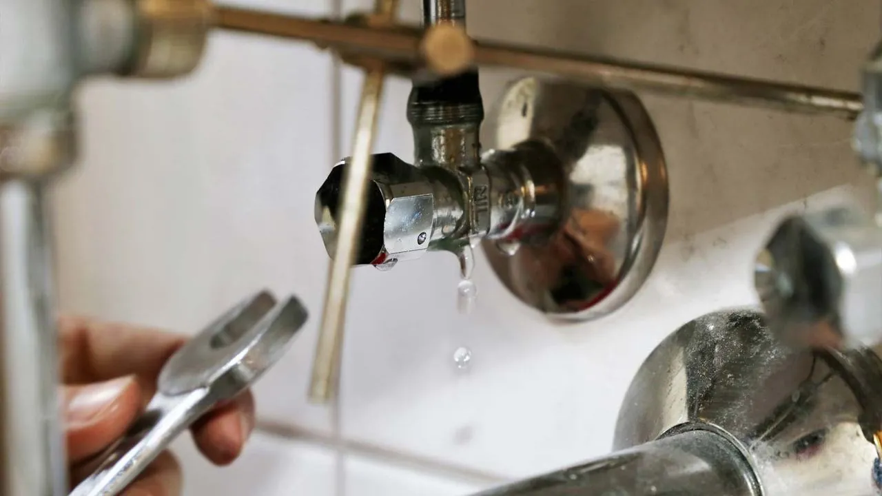 Wrench tightening a leaking shutoff valve