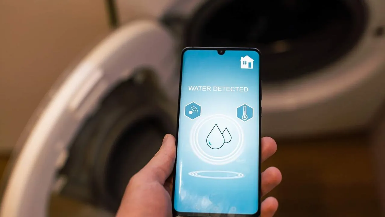 Phone showing a water leak alert from a smart leak detector