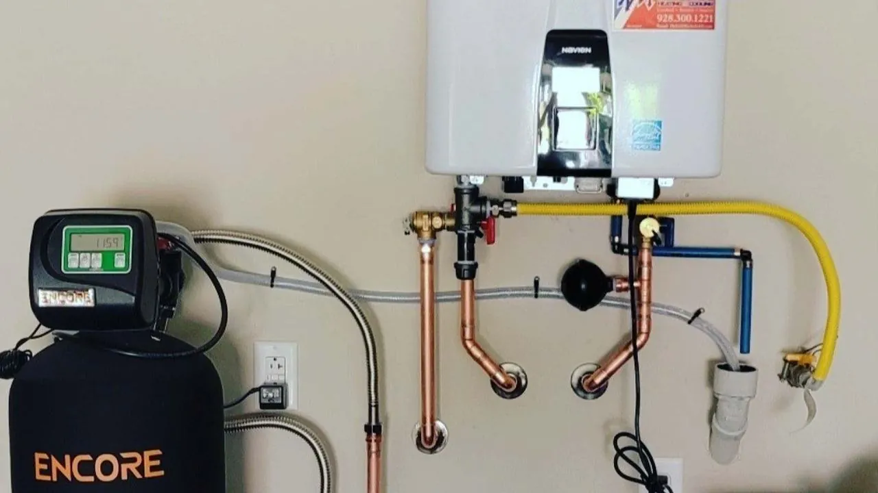 Wall-mounted tankless water heater installed next to a water softener