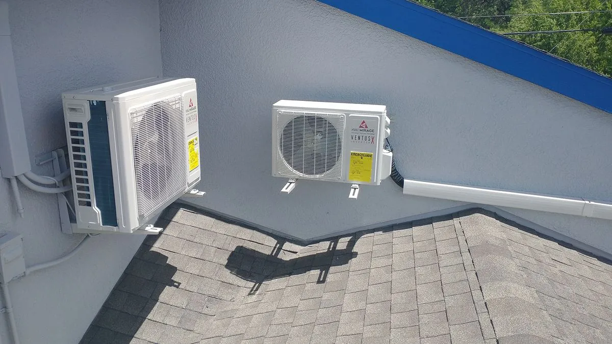Two ductless mini-split outdoor units mounted on a wall