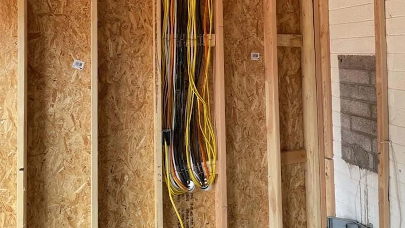 Electrical rough-in wiring run through wall studs
