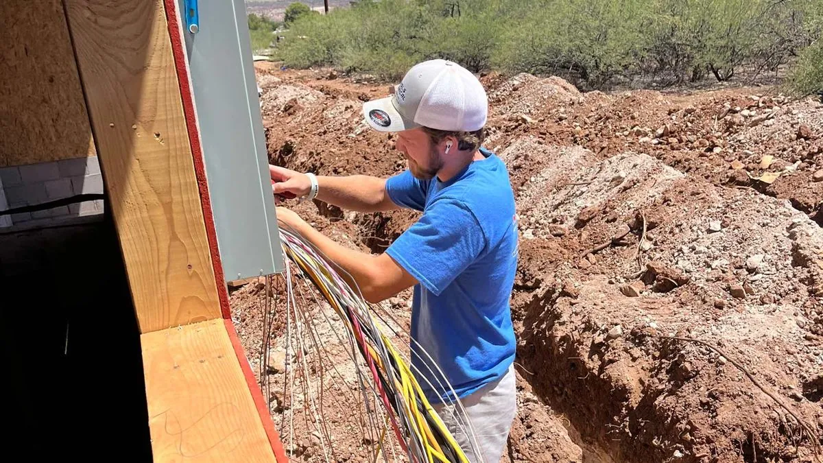 Electrician wiring a new electrical service panel