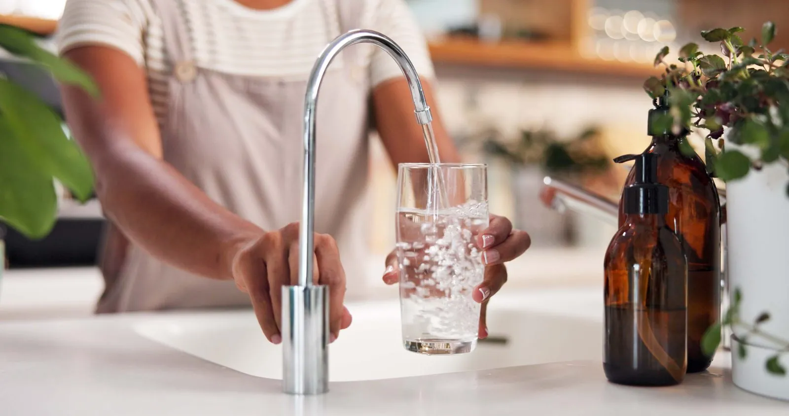 Filling a glass with filtered water from a drinking water faucet