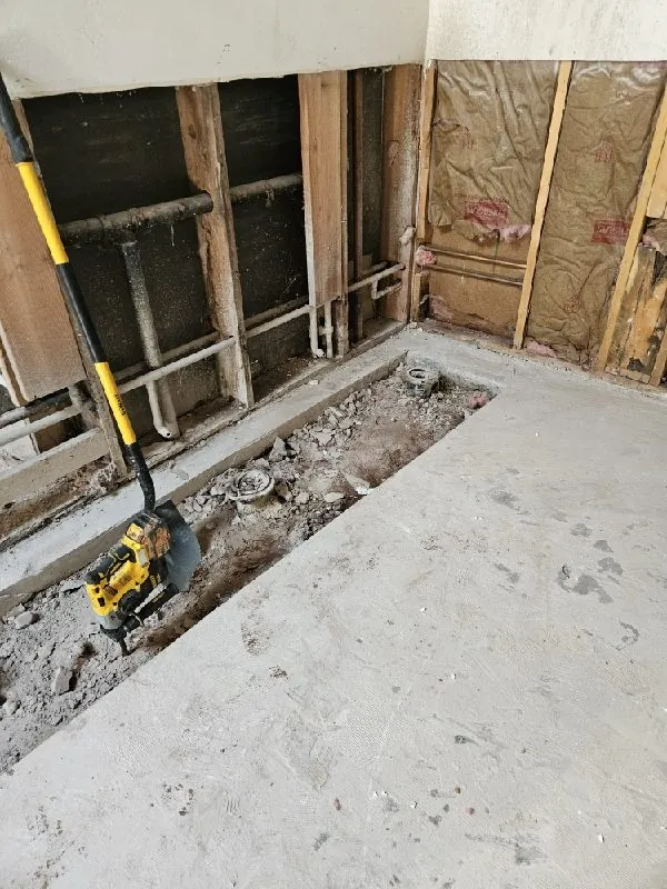 Concrete floor cut open with a jackhammer for a slab leak repair