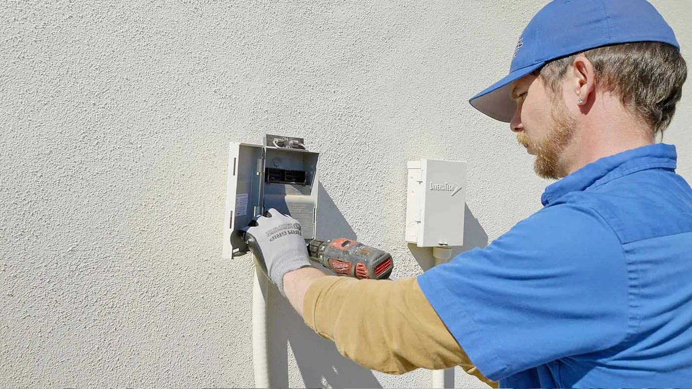 Nichols electrician working on an outdoor electrical disconnect