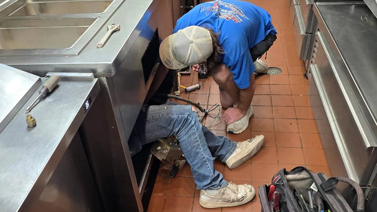 Nichols plumber repairing plumbing in a commercial kitchen
