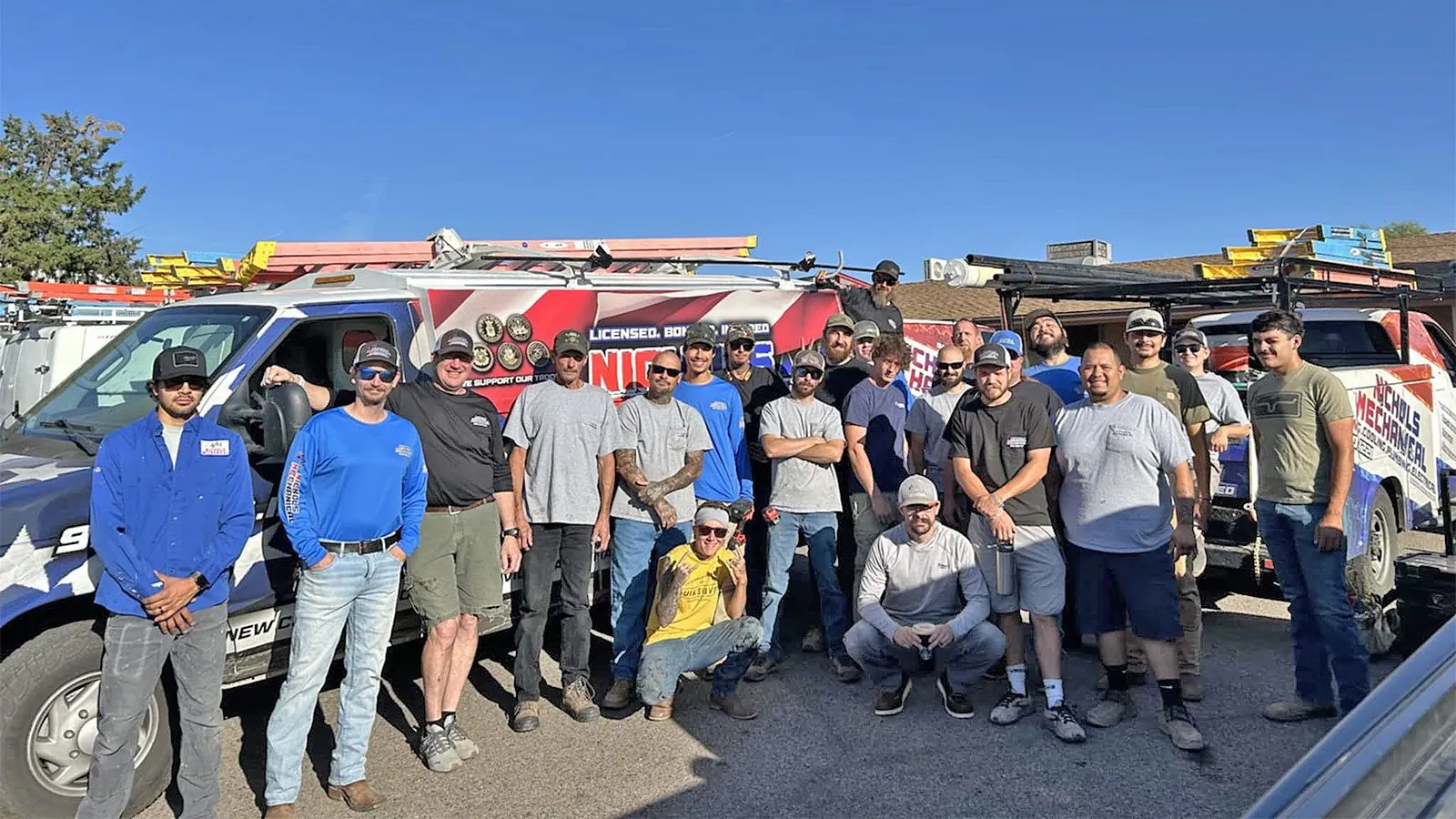 The Nichols team in front of their service trucks