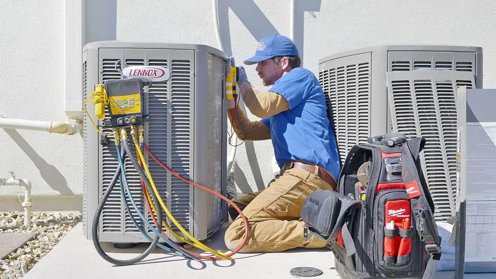 Nichols technician checking AC refrigerant levels with gauges