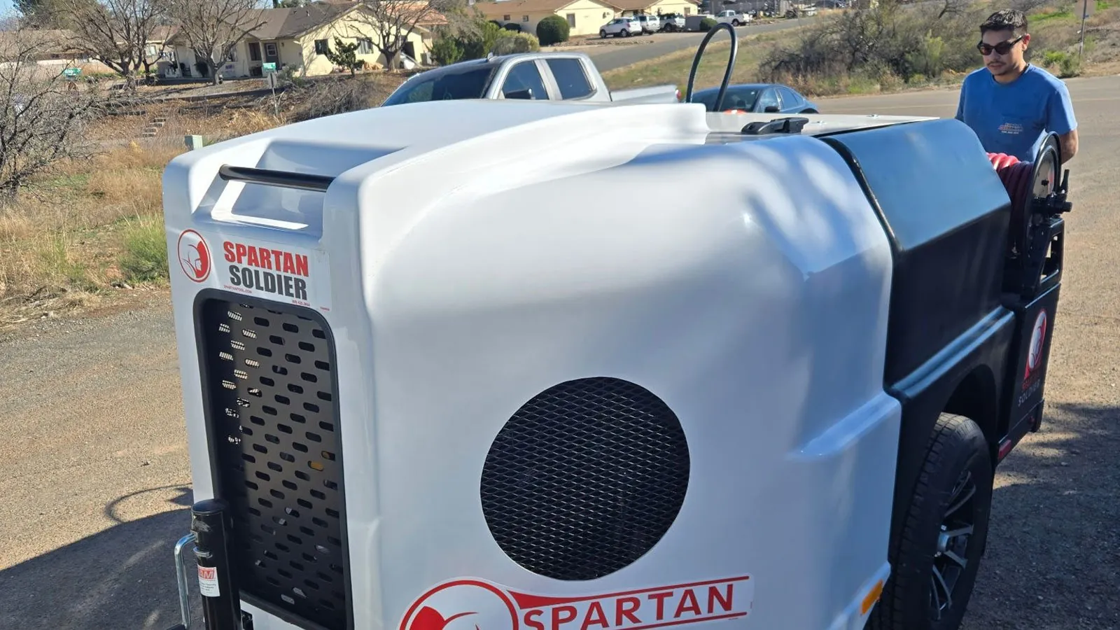 Nichols technician with a hydro jetting trailer on a service call