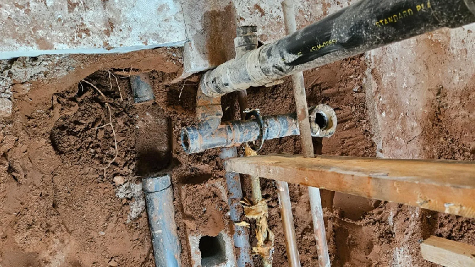 Old water lines exposed under a slab for repair