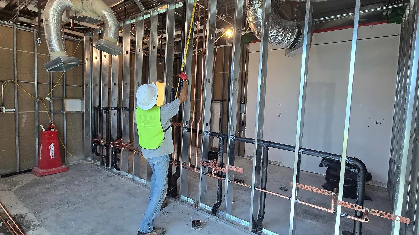 Plumber running copper lines in a commercial build-out