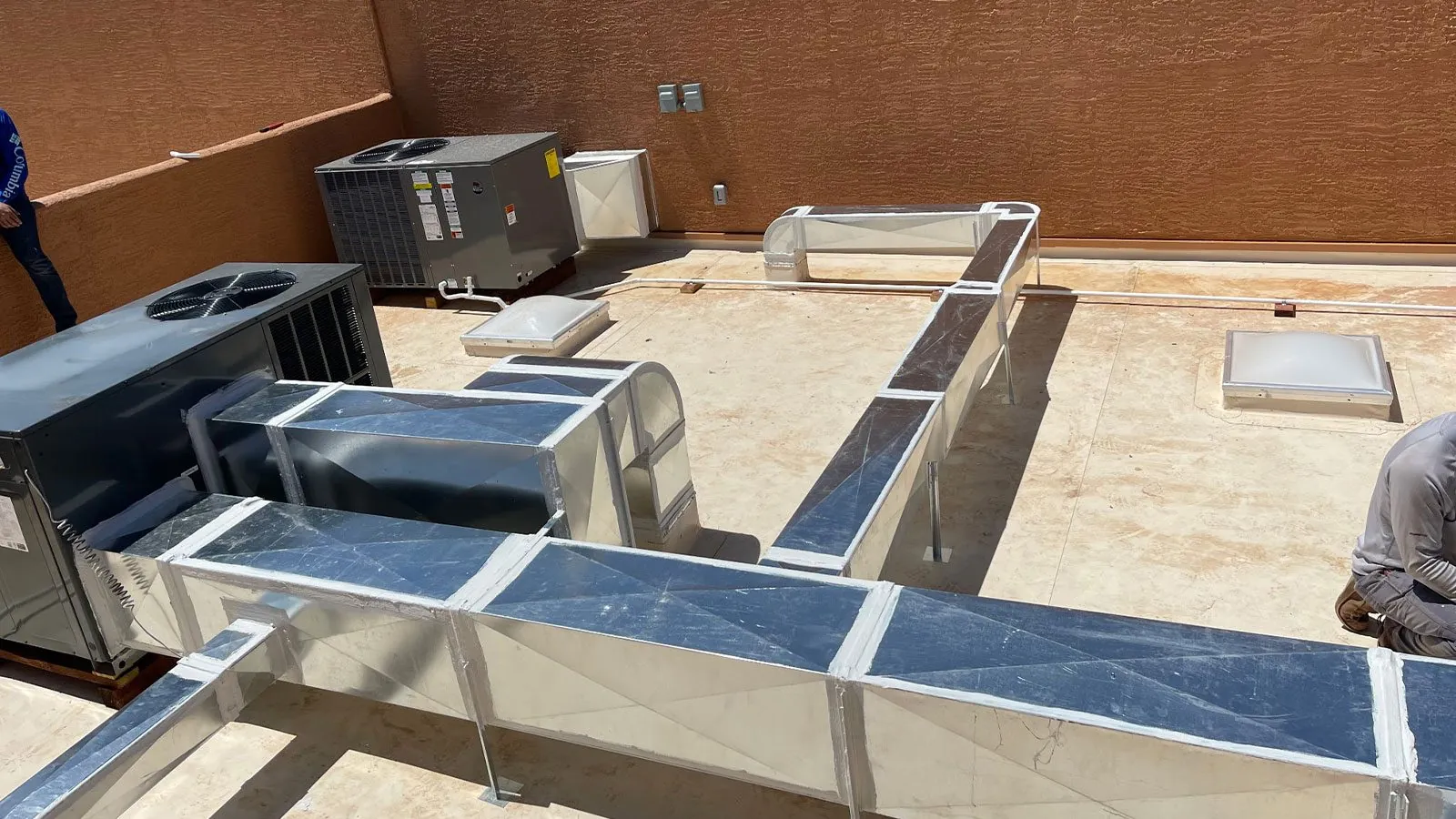 Rooftop HVAC units and ductwork on a commercial building
