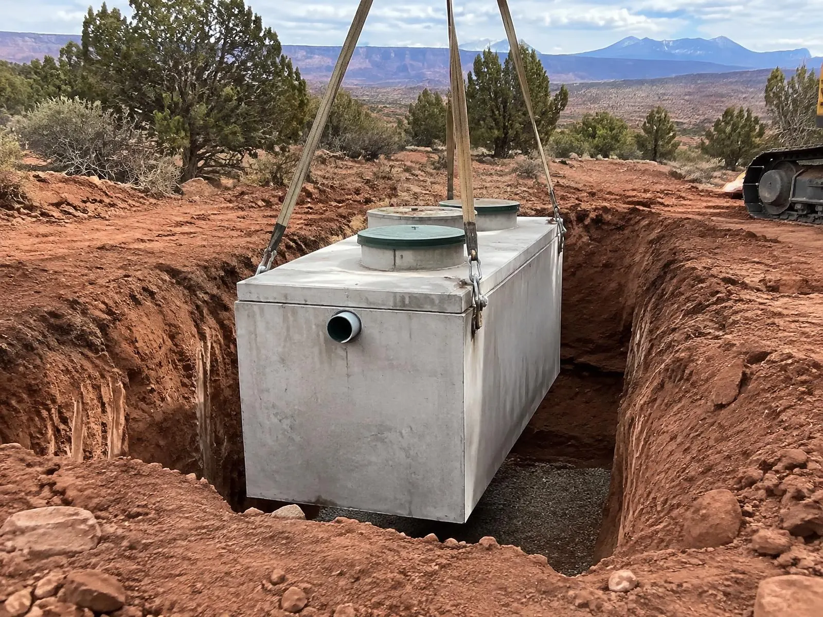 New concrete septic tank being lowered into place