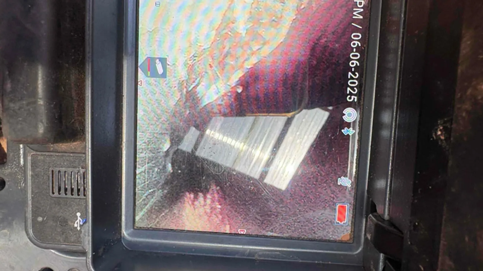 Sewer camera monitor showing the inside of a drain line