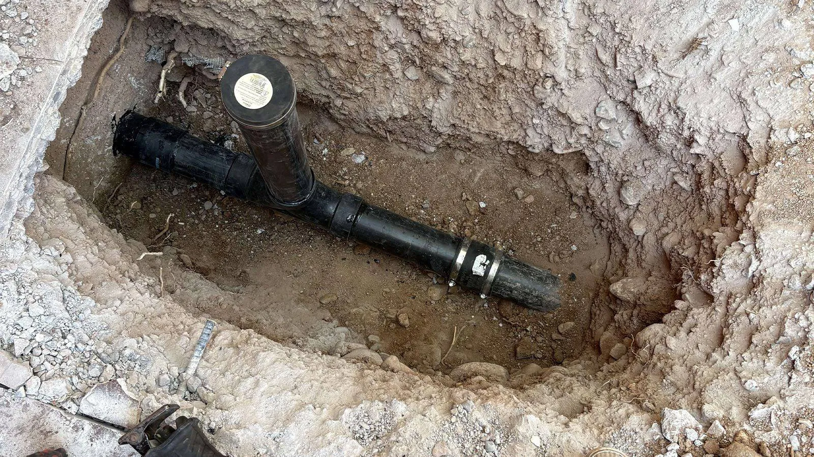 Repaired sewer line with a new cleanout in an excavated hole