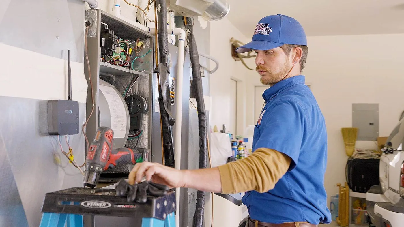 Nichols technician servicing a home furnace